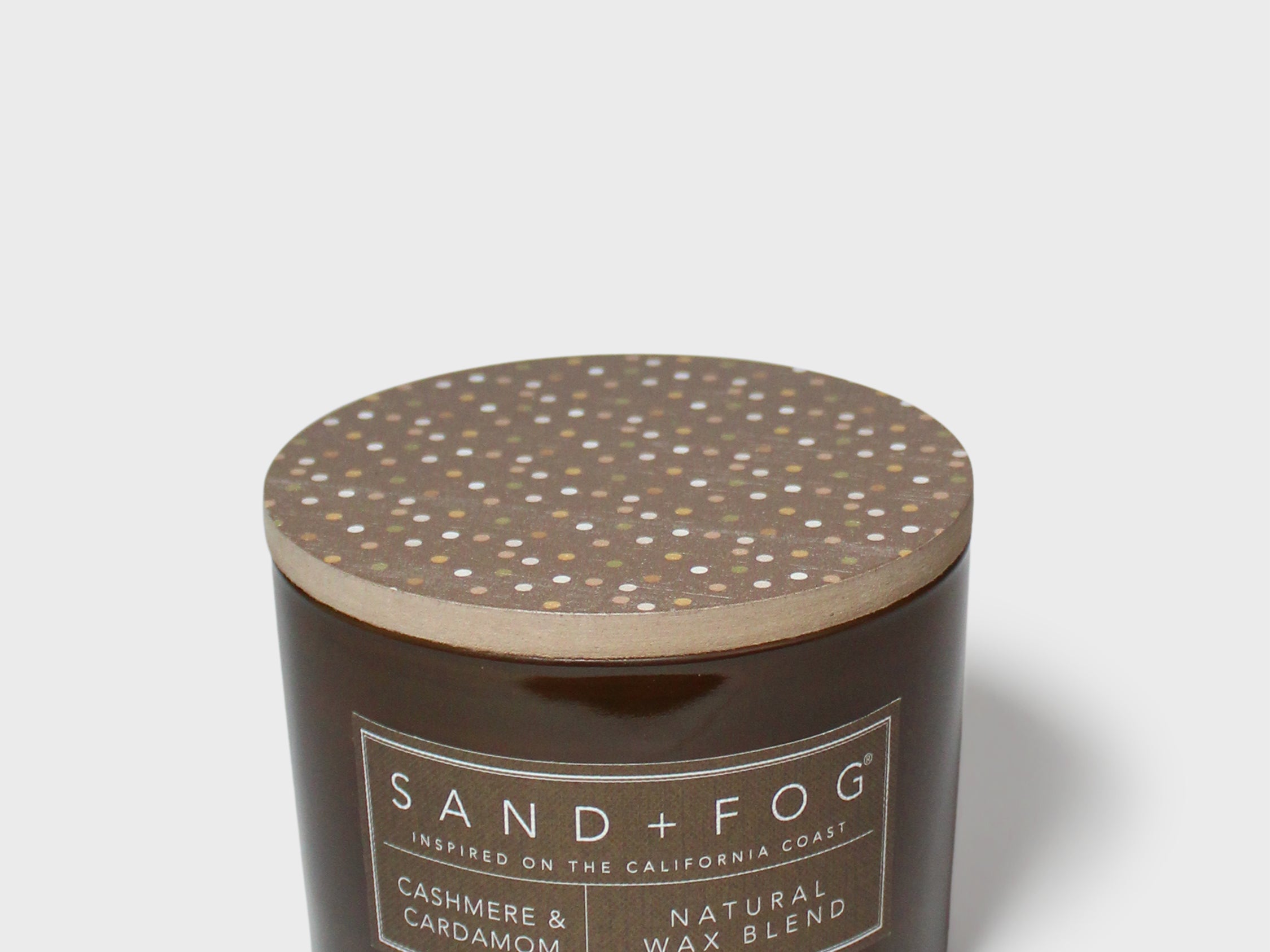 Brown candle jar with speckled top lid and SAND+FOG label