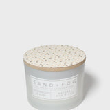12 oz scented candle with speckled wooden lid and SAND + FOG label