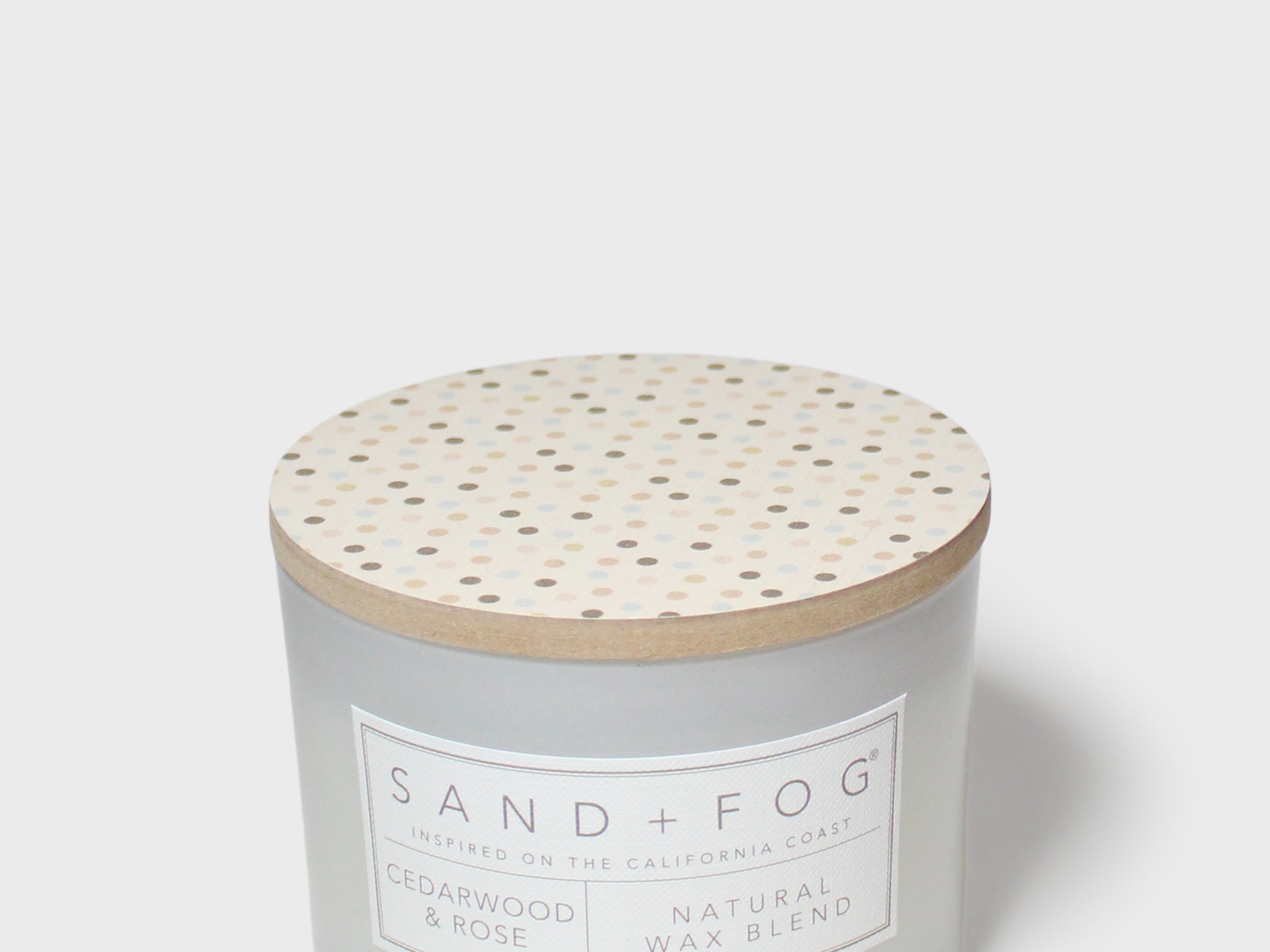12 oz scented candle with speckled wooden lid and SAND + FOG label