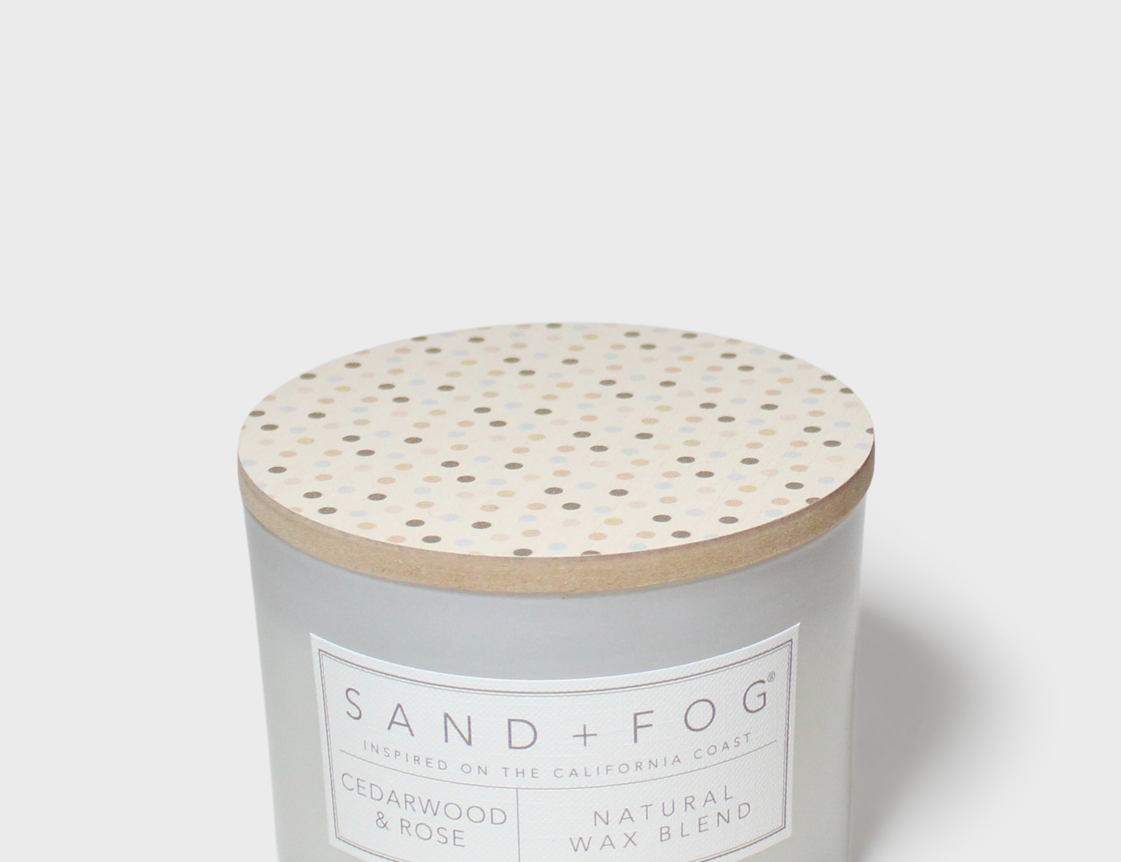 12 oz scented candle with speckled wooden lid and SAND + FOG label