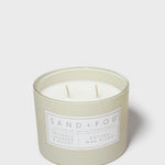 12 oz scented candle in frosted green jar with SAND+FOG label and white wax