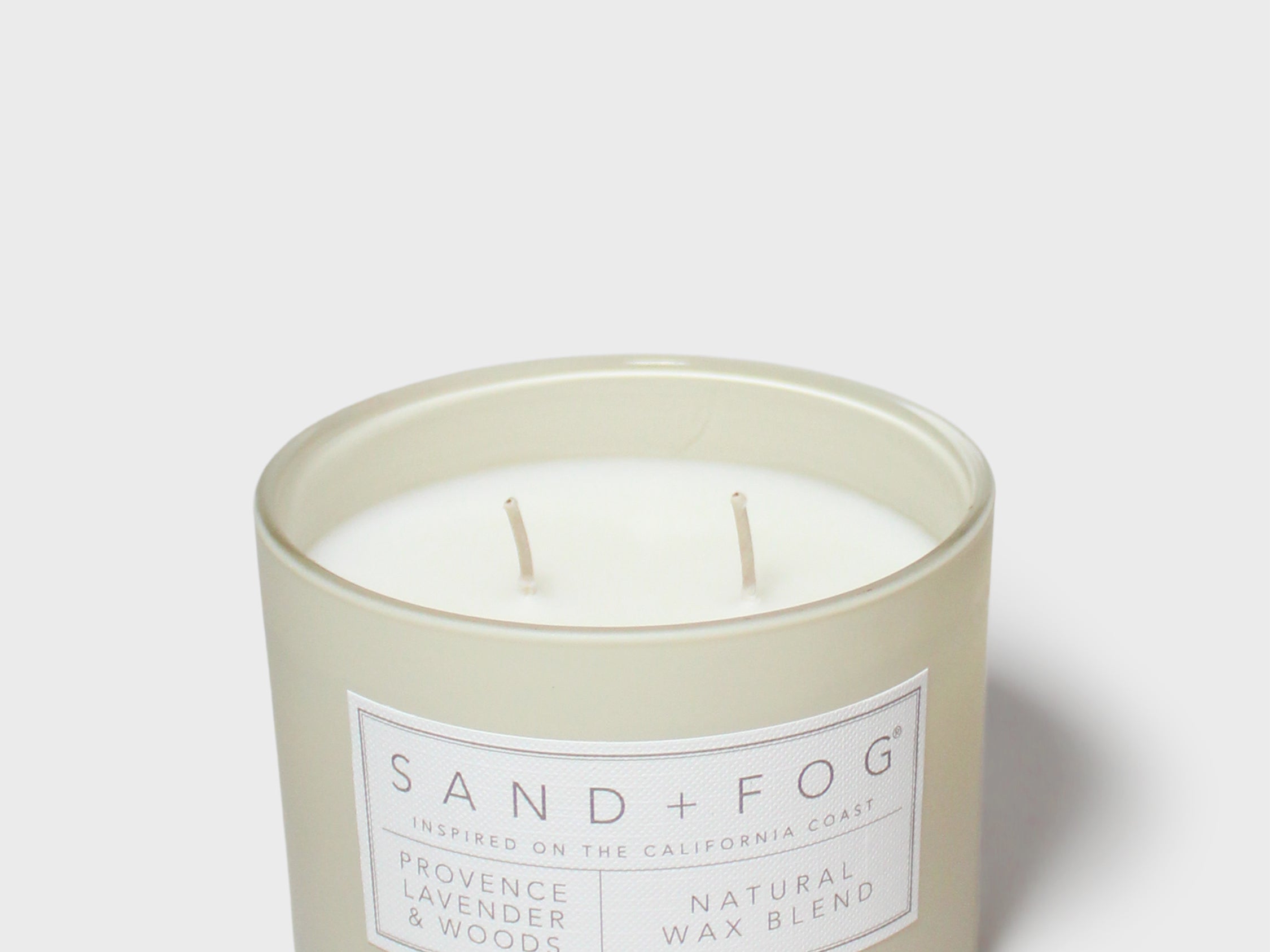 12 oz scented candle in frosted green jar with SAND+FOG label and white wax