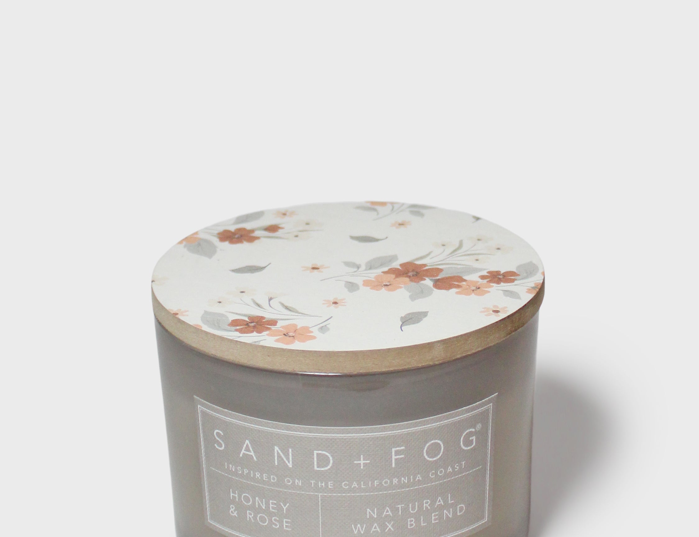 Scented candle jar with floral lid top in white with peach flower and leaf print