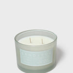 Scented candle jar with pale wax, two wicks, Sand+Fog label
