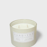 Sand + Fog scented candle in glass jar with Sweet Lemon label