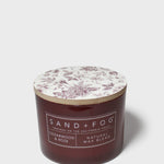 SAND+FOG cedarwood & rose scented candle with floral lid and dark maroon glass jar