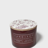 SAND+FOG cedarwood & rose scented candle with floral lid and dark maroon glass jar
