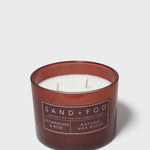 SAND+FOG cedarwood & rose scented candle in dark maroon glass jar with two wicks