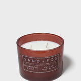 SAND+FOG cedarwood & rose scented candle in dark maroon glass jar with two wicks