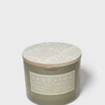 SAND+FOG 12 oz scented candle with patterned lid and Pistachio Dream wax blend label