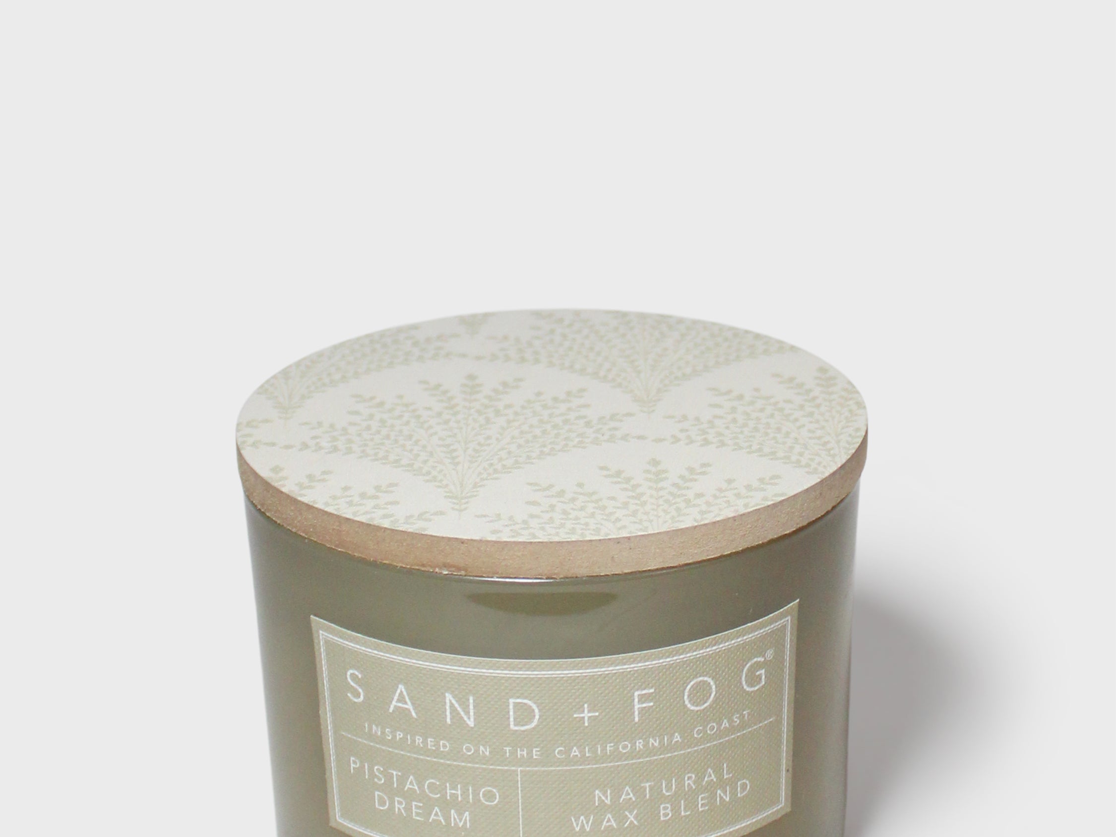 SAND+FOG 12 oz scented candle with patterned lid and Pistachio Dream wax blend label