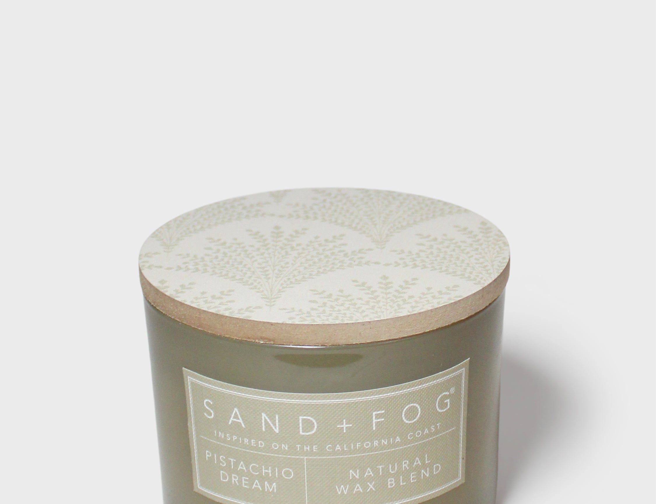 SAND+FOG 12 oz scented candle with patterned lid and Pistachio Dream wax blend label