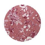 Scented candle wax top with pink floral botanical pattern on dark surface