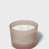 Sand+Fog Amber & Pear 12 oz candle in frosted brown glass with three wicks