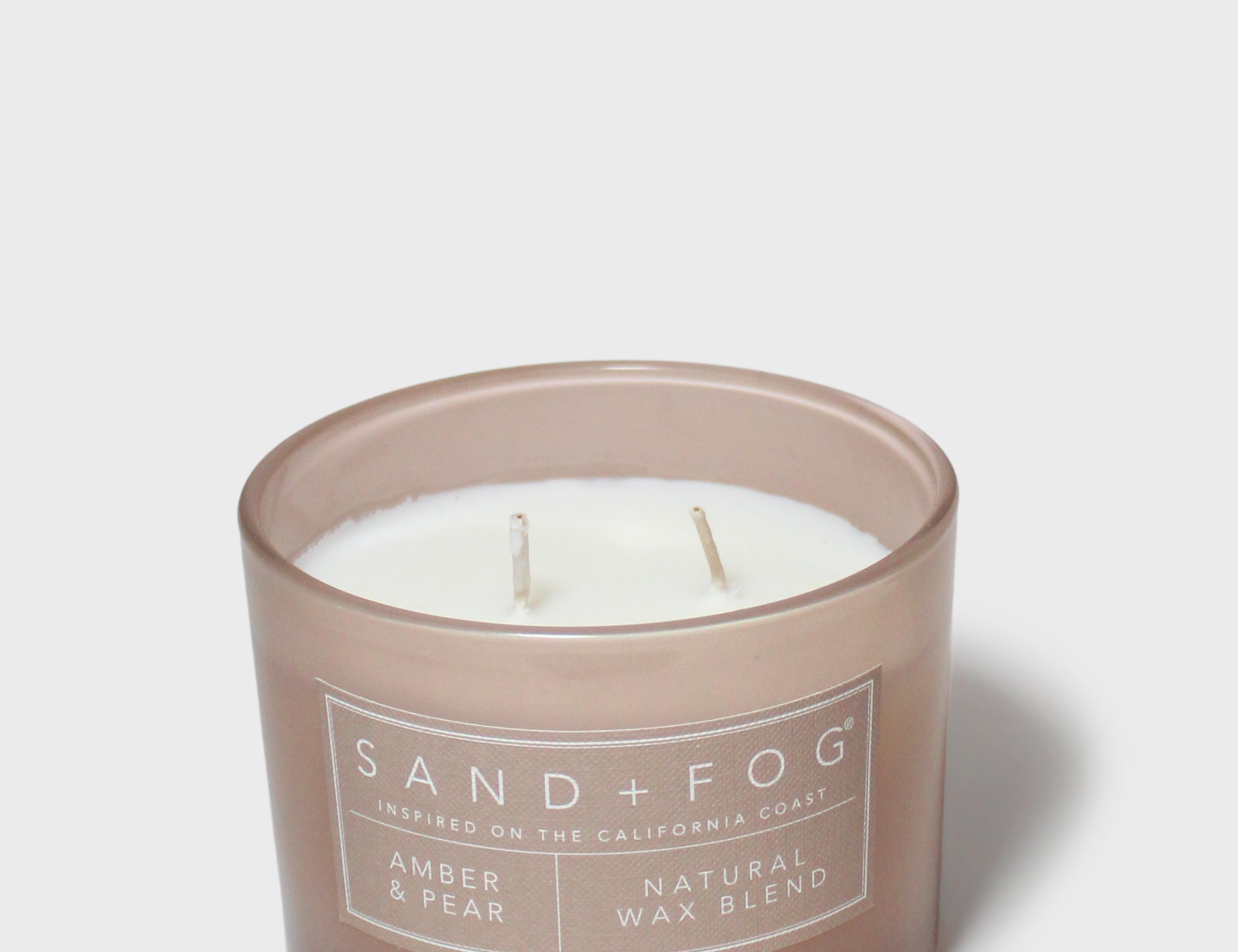 Sand+Fog Amber & Pear 12 oz candle in frosted brown glass with three wicks