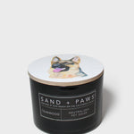 12 oz scented candle with black jar, dog lid graphic, and label text