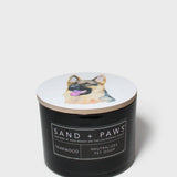 12 oz scented candle with black jar, dog lid graphic, and label text