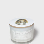 Scented candle jar with dog graphic lid and front label reading Vanilla & Amber