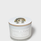 Scented candle jar with dog graphic lid and front label reading Vanilla & Amber