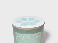 Scented candle jar lid with pale paw-print design on light white top