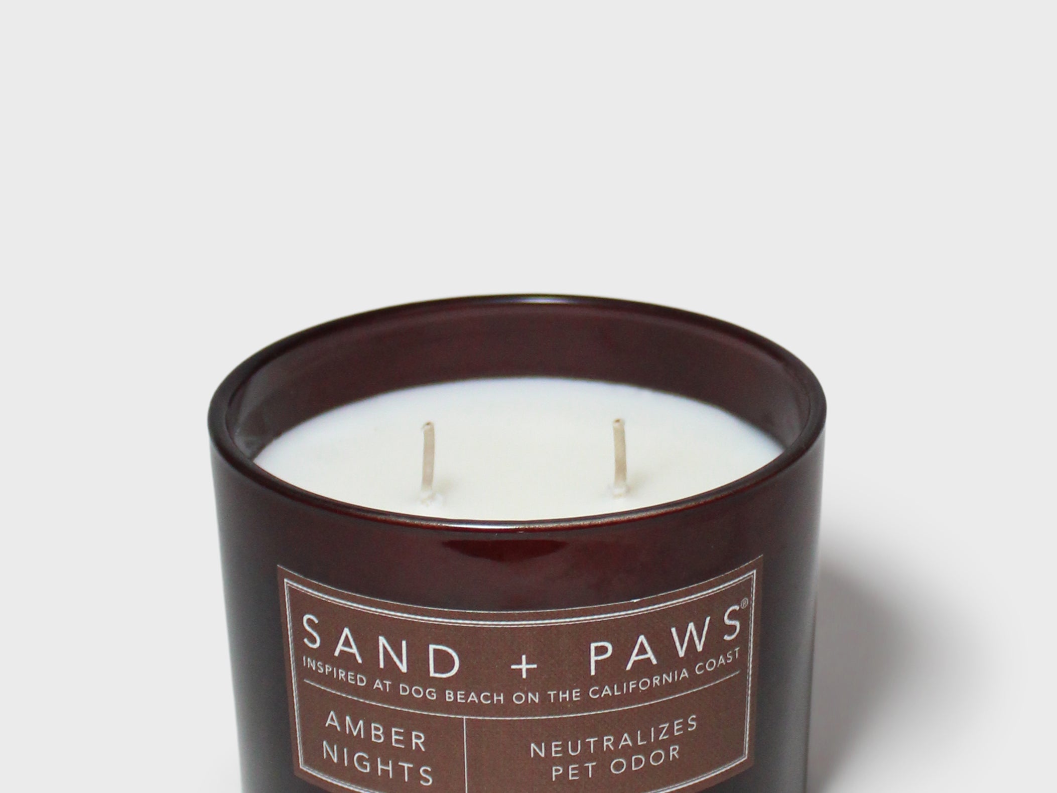 Sand + Paws Amber Nights 12 oz scented candle in dark jar, two wicks