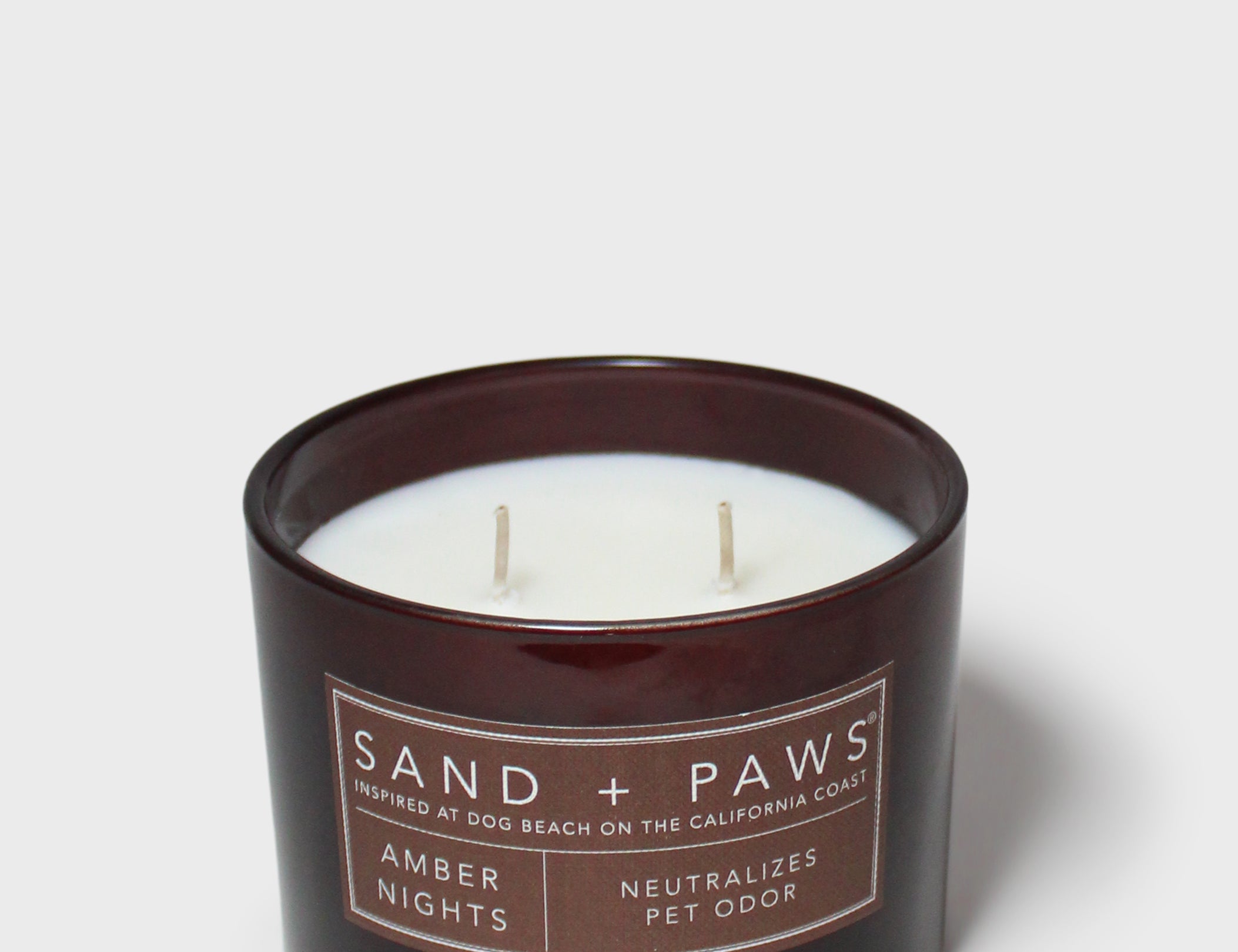 Sand + Paws Amber Nights 12 oz scented candle in dark jar, two wicks
