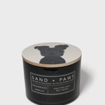 Scented candle with black jar and dog silhouette on the lid