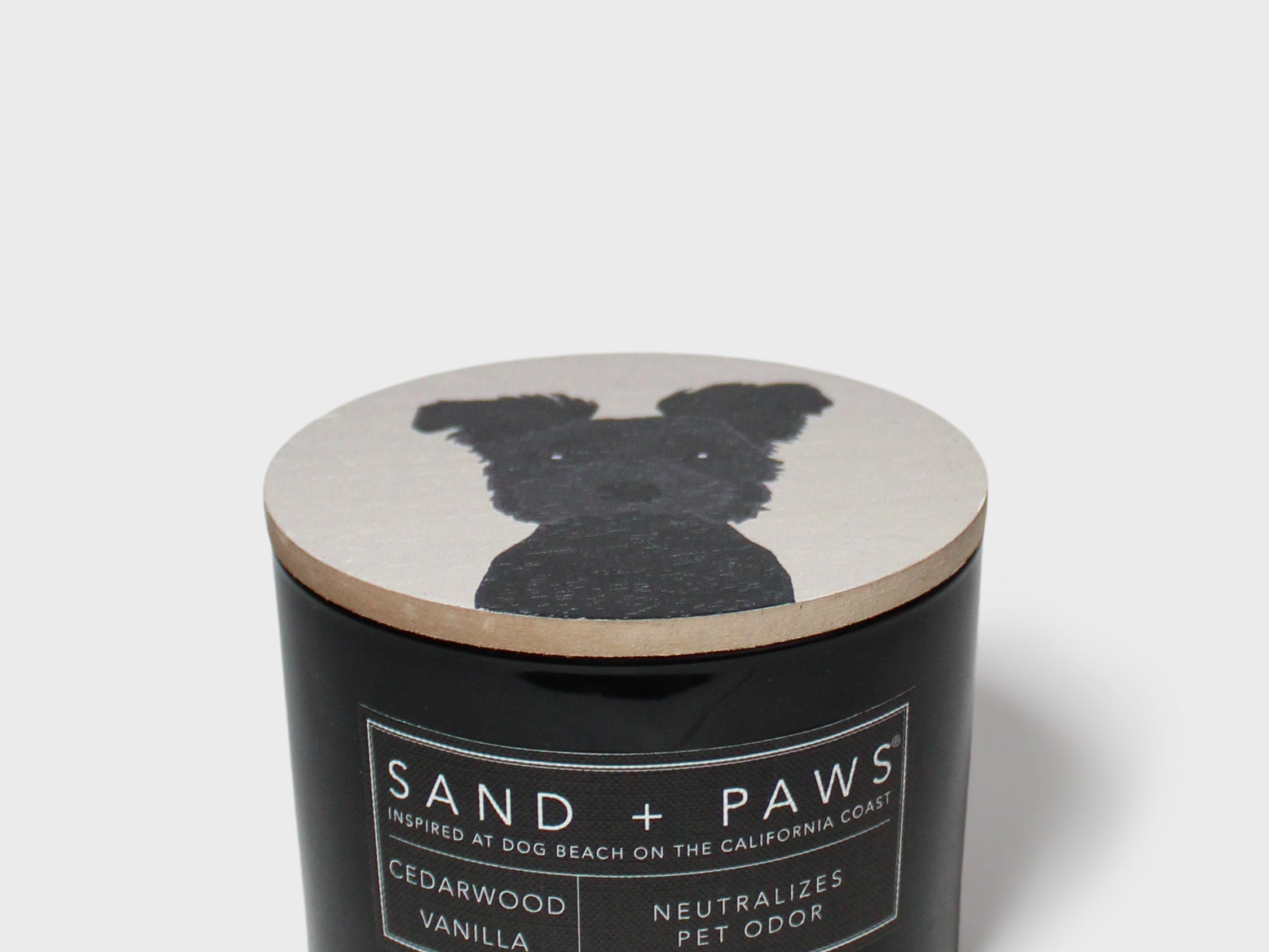 Scented candle with black jar and dog silhouette on the lid