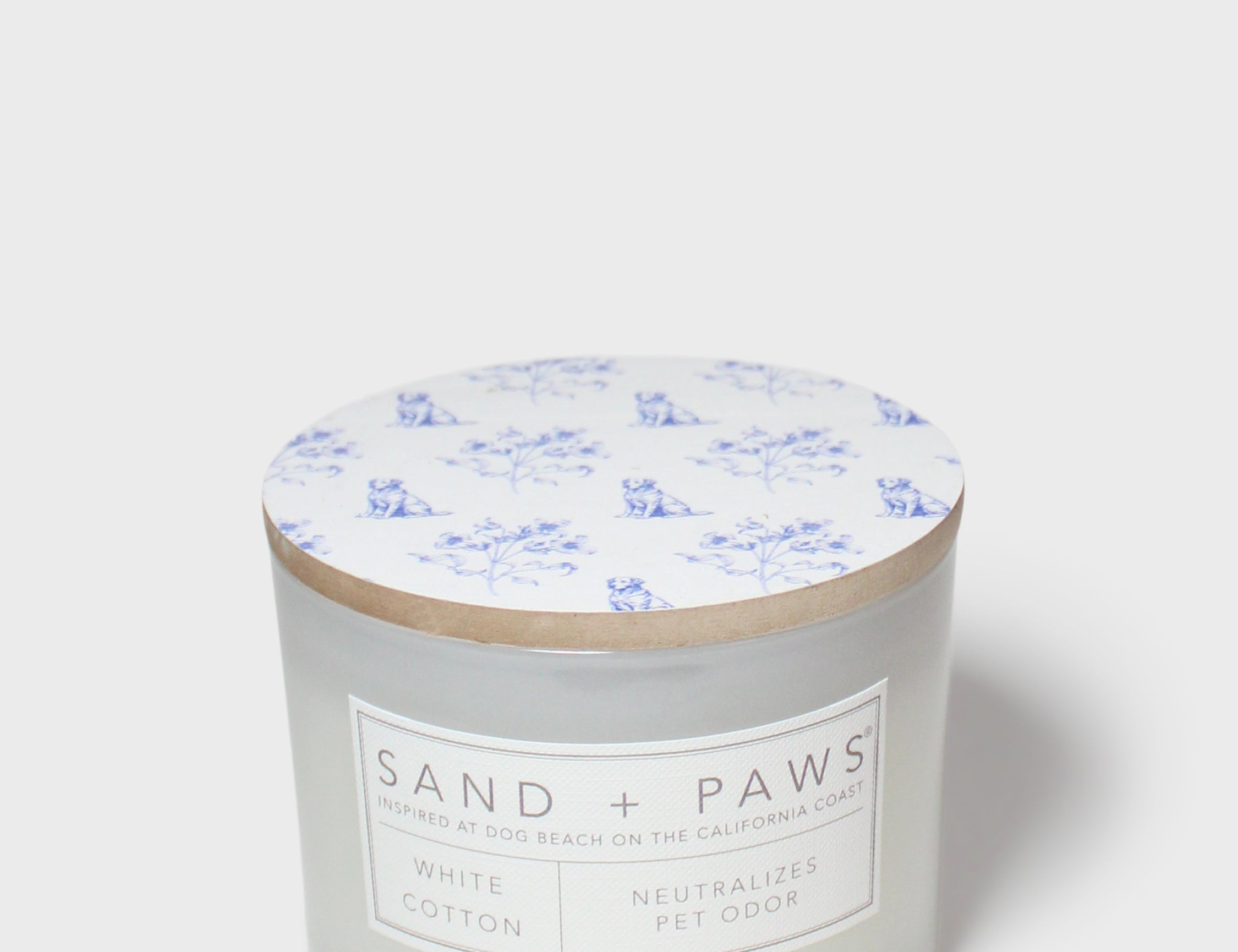 Sand + Paws white cotton scented candle with wood lid and blue dog pattern