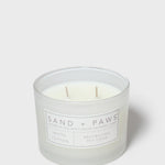 Sand + Paws white cotton scented candle in frosted glass jar with front label