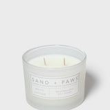Sand + Paws white cotton scented candle in frosted glass jar with front label
