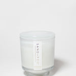 Cashmere & Cardamom candle in a clear glass jar with a white lid and white wax.