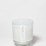 Cashmere & Cardamom candle in a clear glass jar with a white lid and white wax.