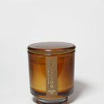 Western Oak 8 oz scented candle in an amber glass jar with its matching lid on.