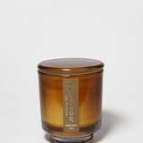 Western Oak 8 oz scented candle in an amber glass jar with its matching lid on.
