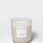 Vanilla Musk scented candle with flame, frosted glass jar, Sand+Fog label
