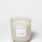 Vanilla Musk scented candle with flame, frosted glass jar, Sand+Fog label
