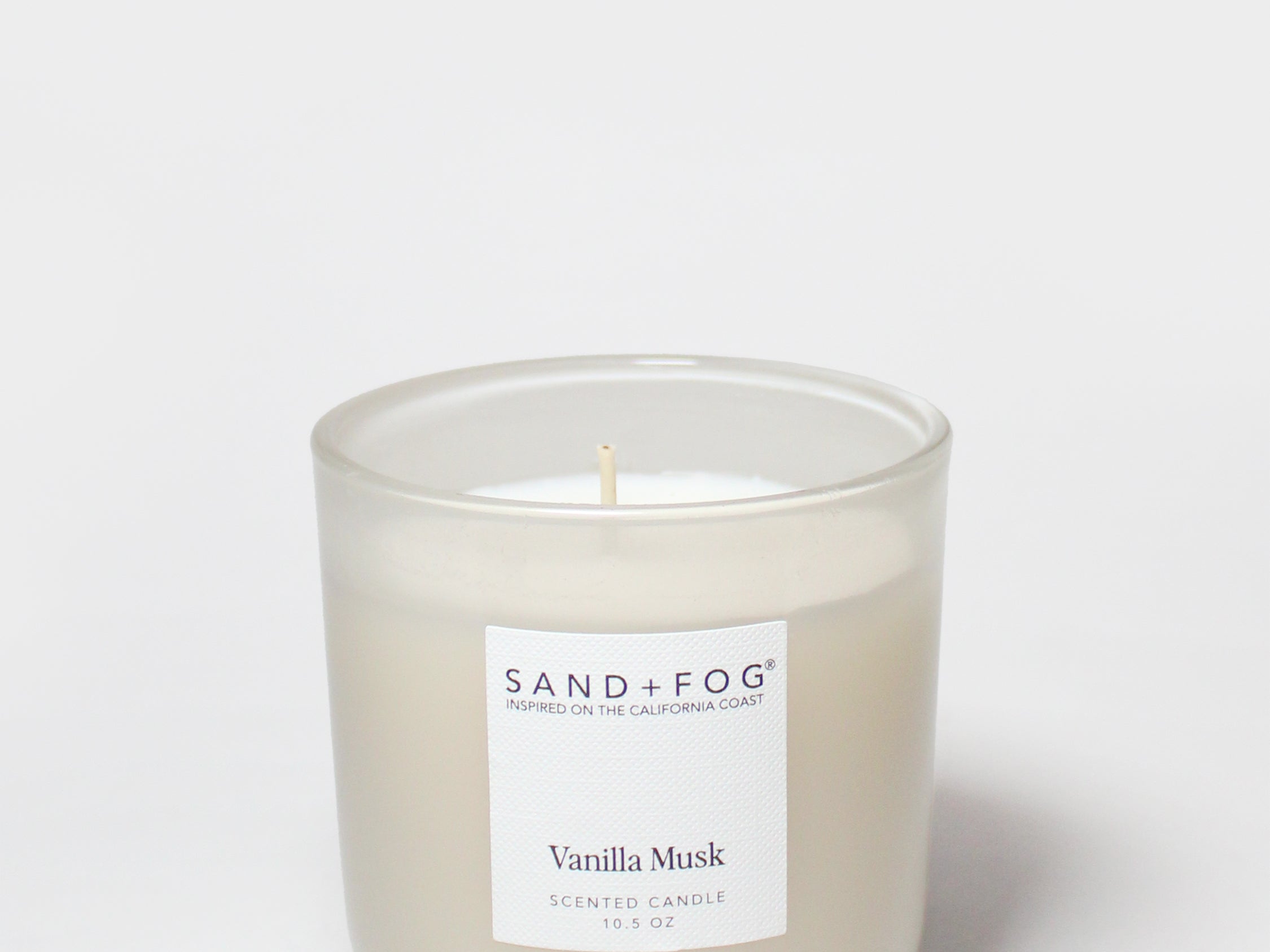 Vanilla Musk scented candle with flame, frosted glass jar, Sand+Fog label