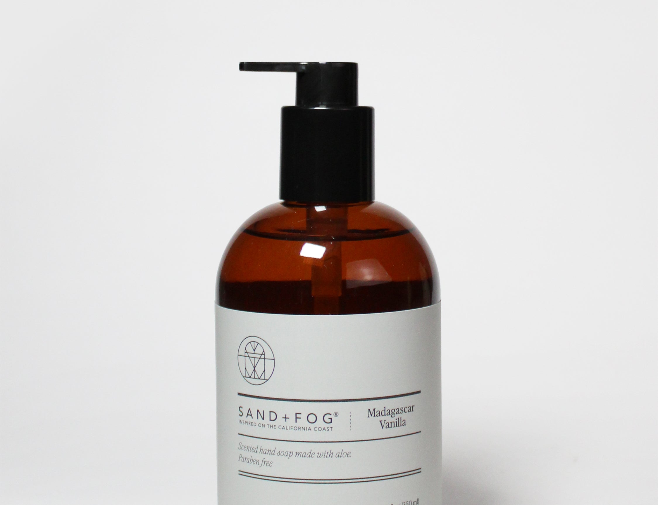 Amber glass liquid hand soap bottle with black pump, vanilla scent label