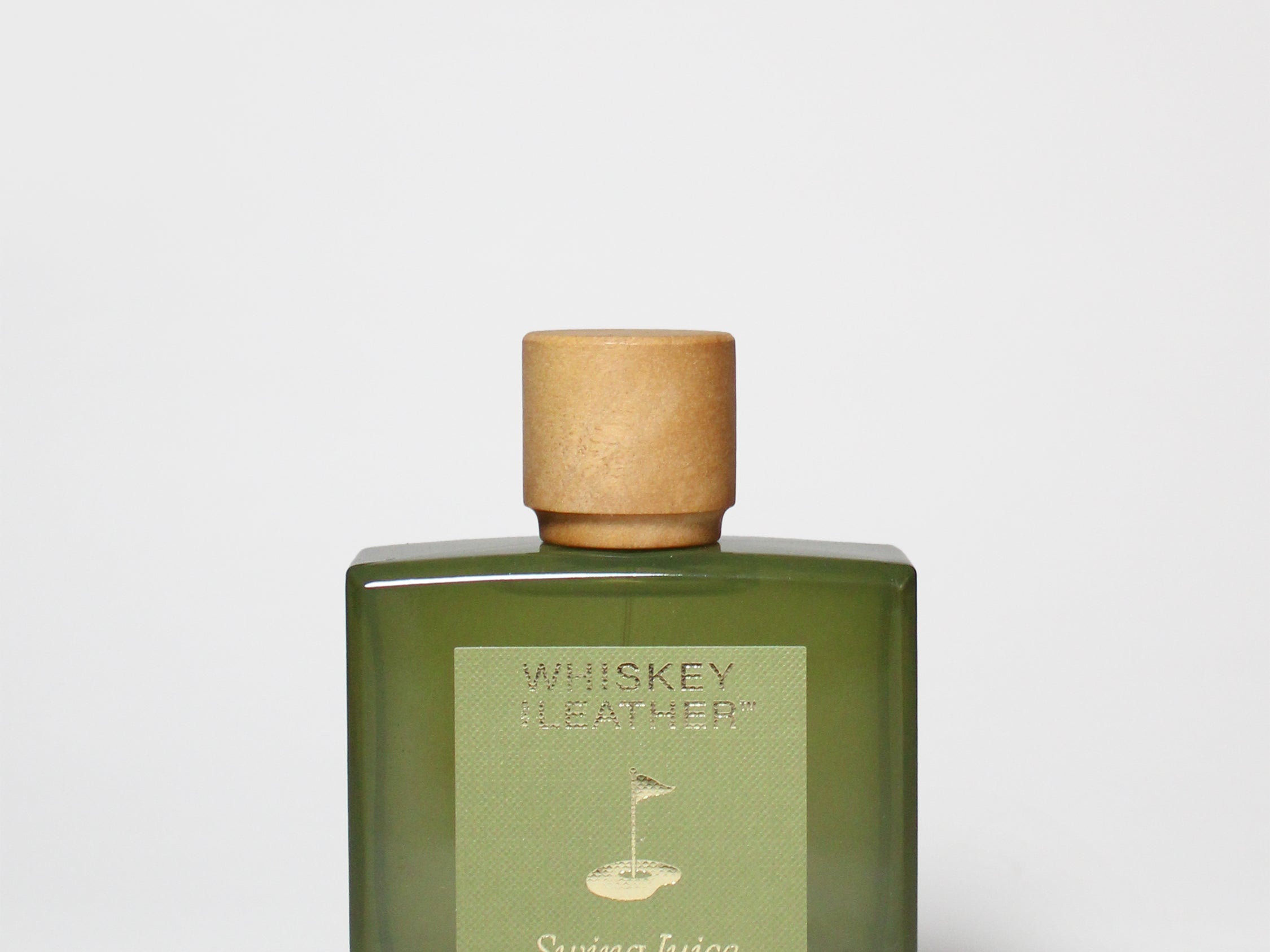 Green eau de cologne bottle with cork stopper and Swing Juice label