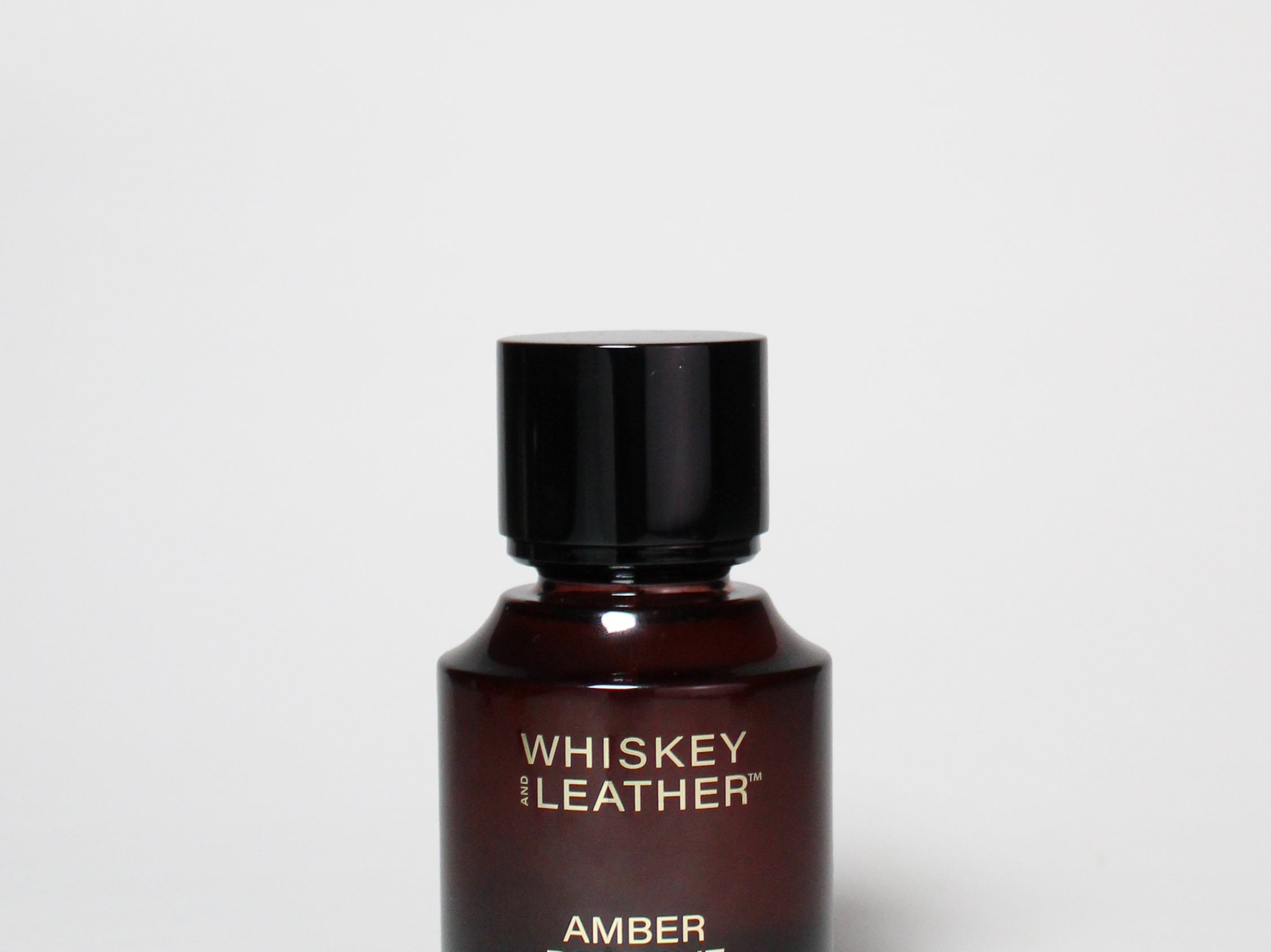 Amber Reserve cologne bottle with black cap, amber glass, printed label