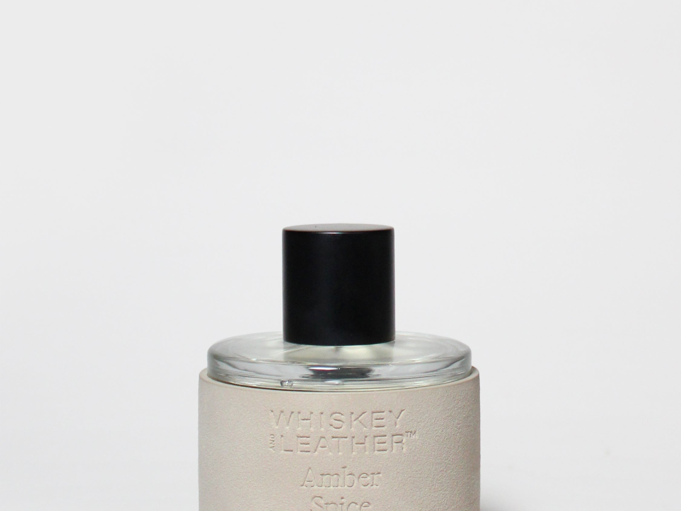 Amber Spice eau de toilette bottle with black cap, clear glass