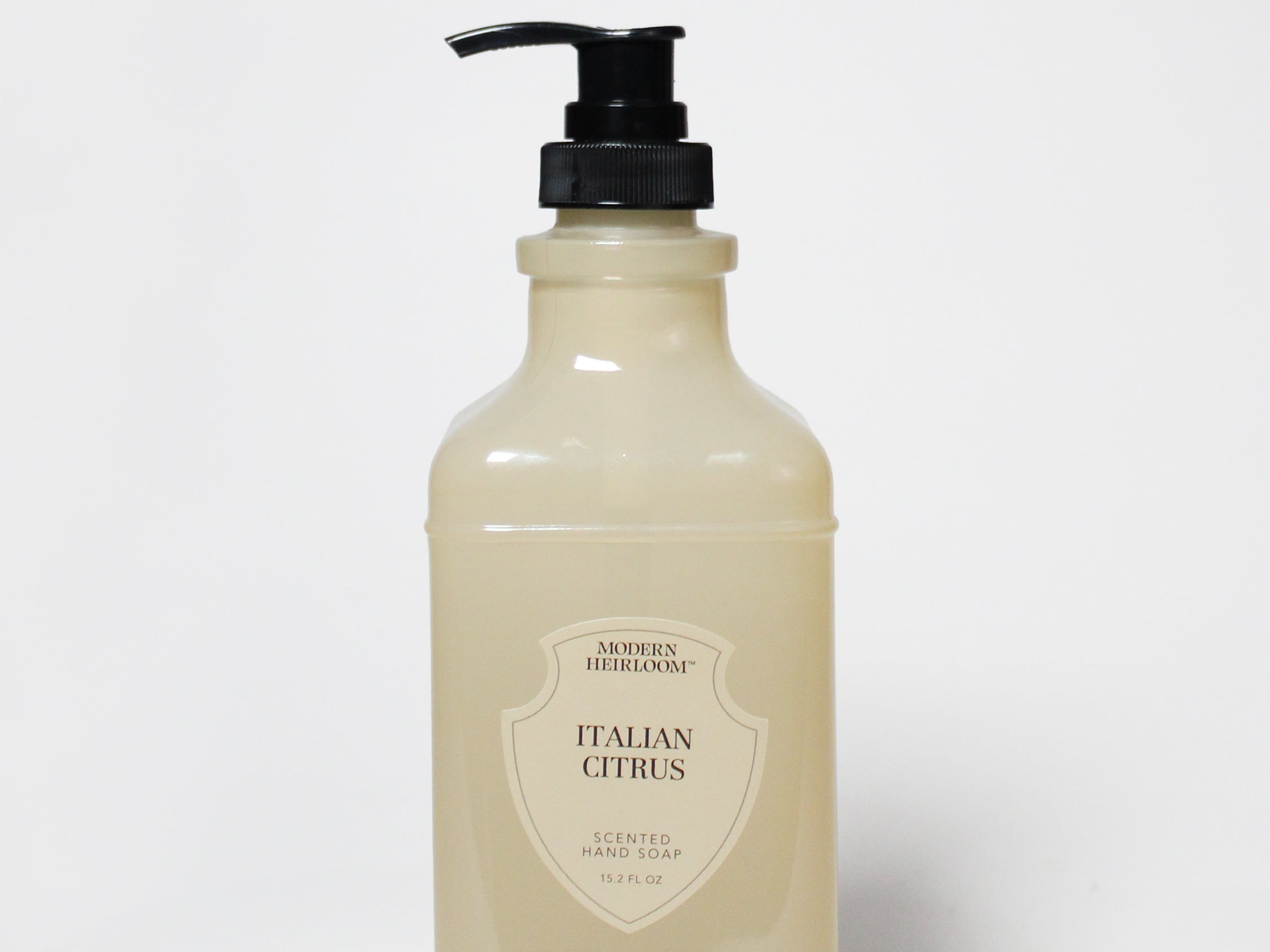 Cream liquid hand soap bottle with black pump, label reading Italian Citrus.