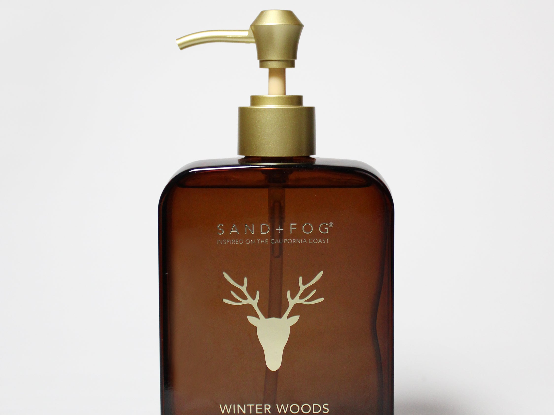 Amber glass liquid hand soap bottle with gold pump; Winter Woods scent