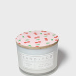 Scented candle with patterned top lid and front label