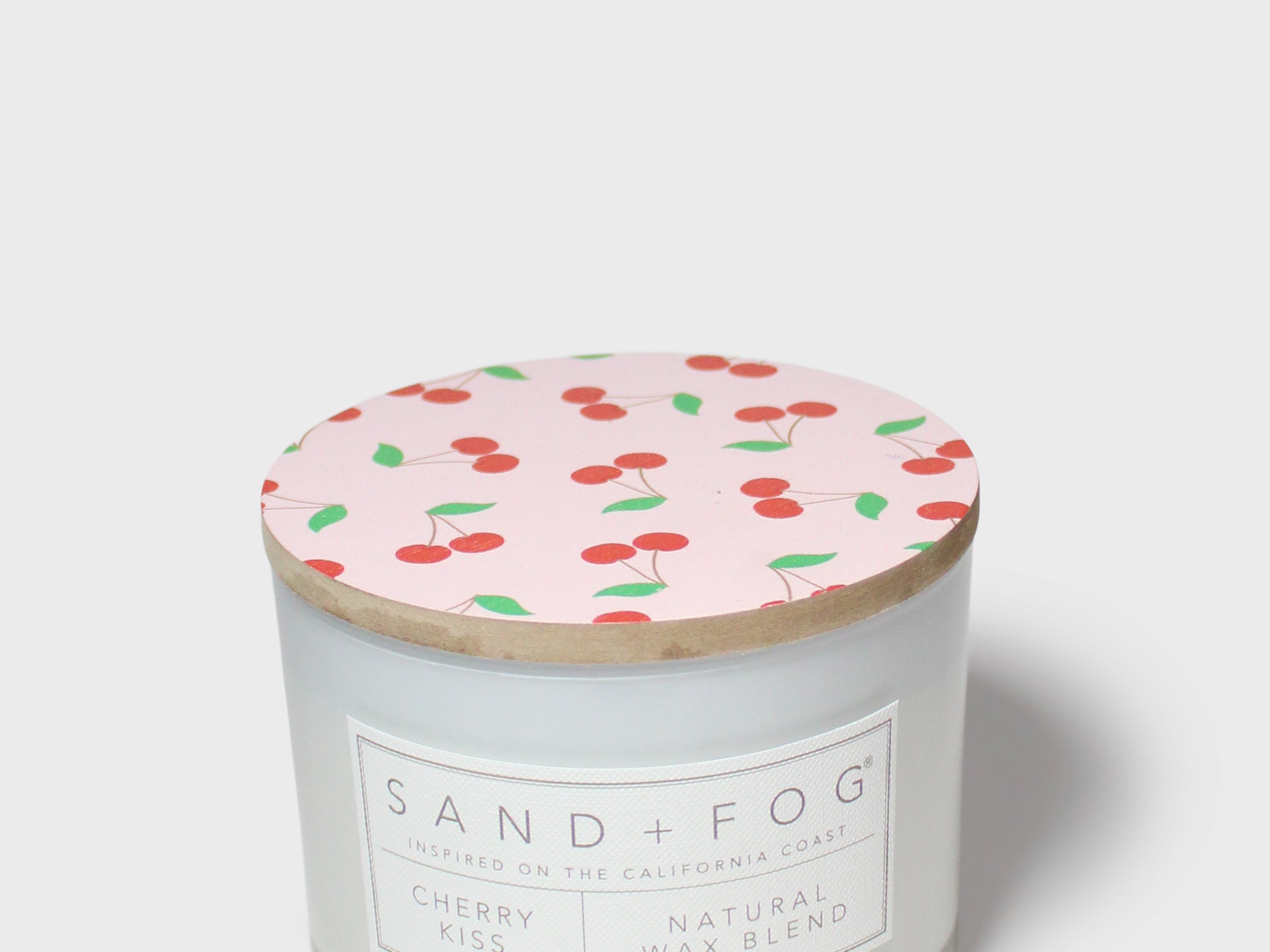 Scented candle with patterned top lid and front label