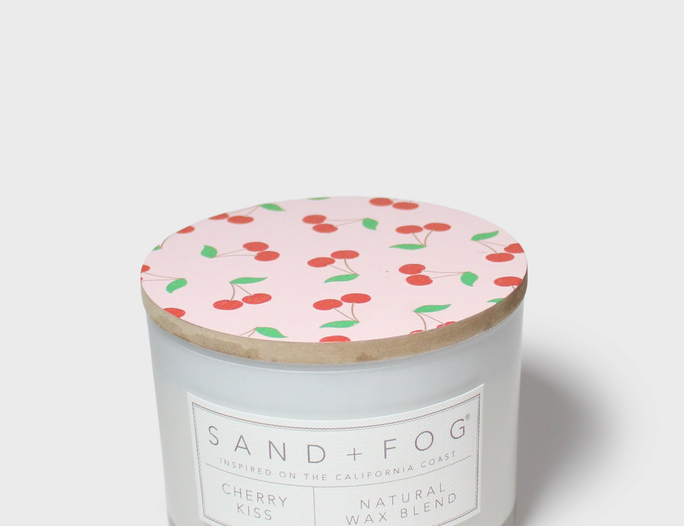 Scented candle with patterned top lid and front label