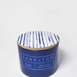 Clean Waves scented candle in a navy glass jar with a blue-and-white patterned lid