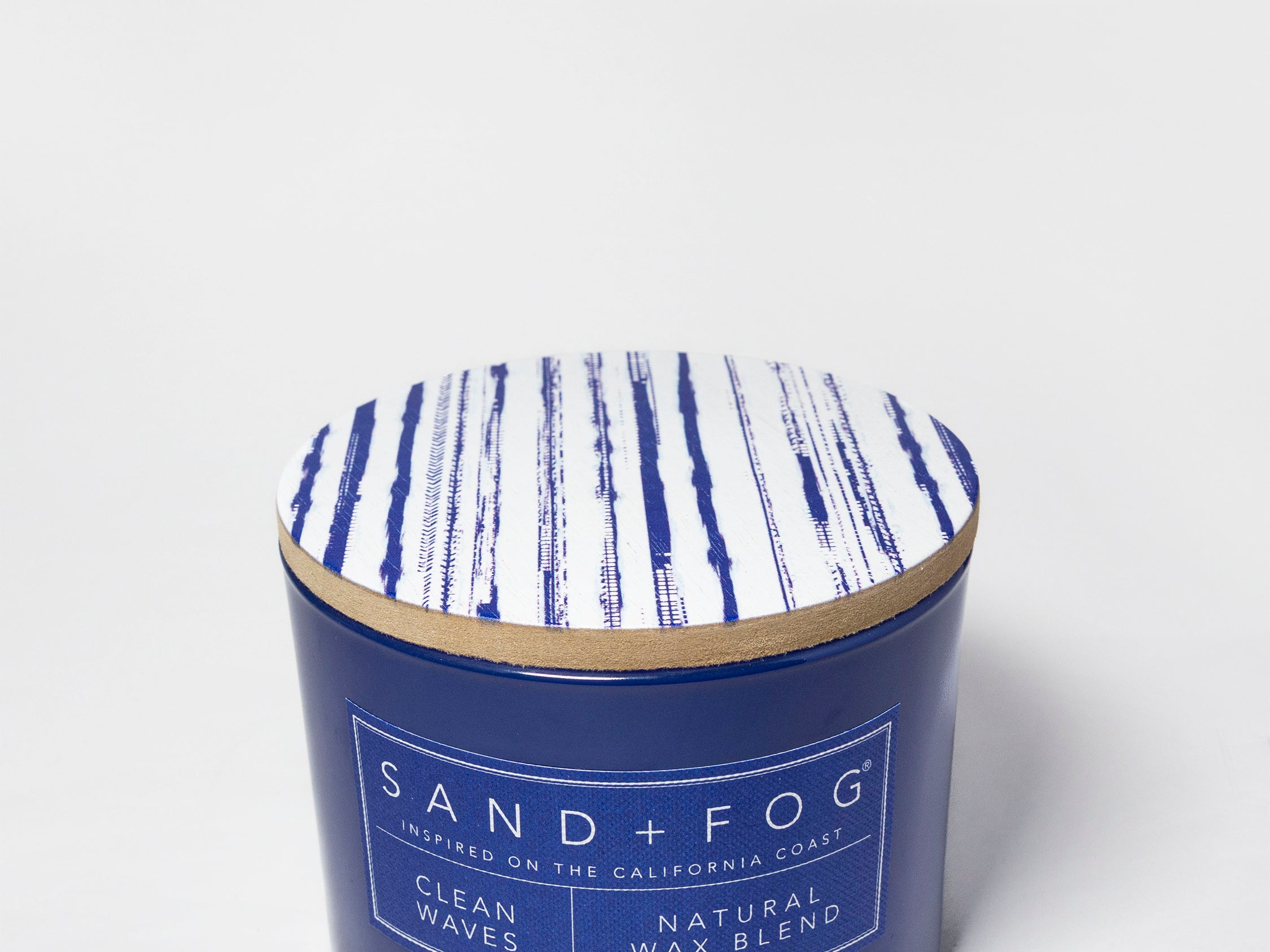 Clean Waves scented candle in a navy glass jar with a blue-and-white patterned lid