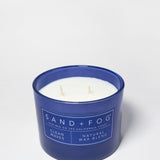 Open Clean Waves candle in a navy glass jar with white wax and two wicks